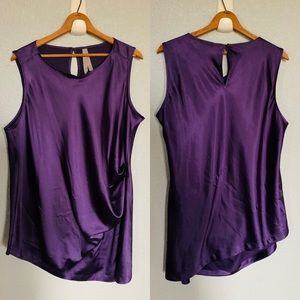 Melissa McCarthy, purple silky asymmetrical tank.